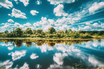 River Landscape With Reflections Of Clouds And Woods In Water. Summer. Sunny Day