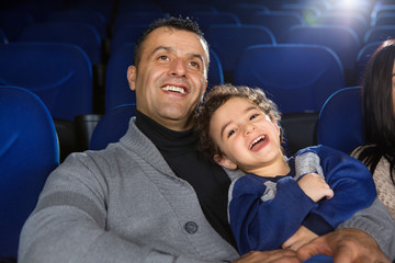 Happy family watching movies at the cinema