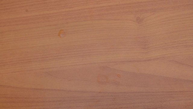 woman holding lot of pink pills in hand than taking one and drink its with water