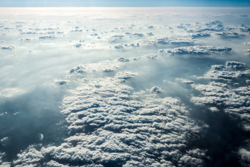 Naklejka na ściany i meble Top view of white clouds above the ground or water