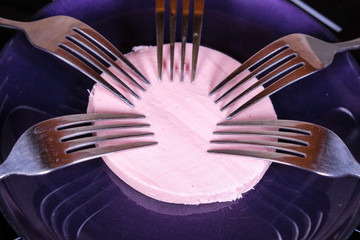 image of 5 forks on a piece of sausage