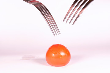 image of a tomato pinned on 2 forks