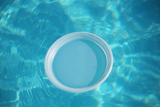 Water texture in blur. On the surface of a plastic plate, layout, mock-up, template. The concept of ecology, cleanliness, recreation, travel. Water in motion, top view.