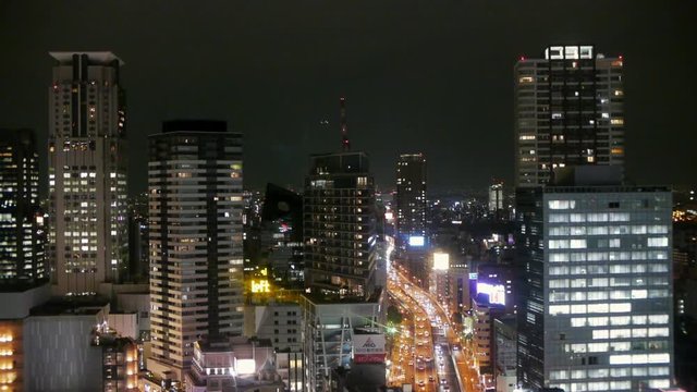 Nightime traffic in Osaka seen from above, city lights and cars.
