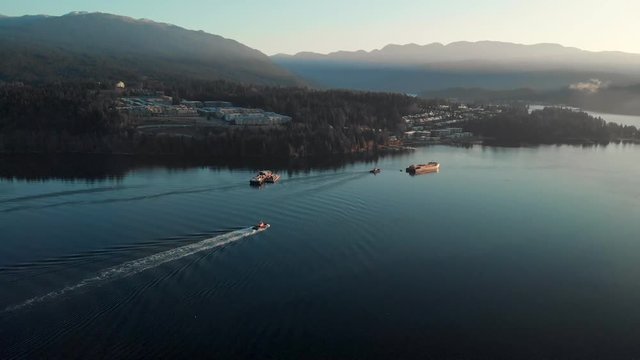 An aerial view of at tug boat in Burrard Inlet near Deep Cove in Vancouver, BC.