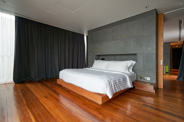 bedroom with wood floor and gray curtain