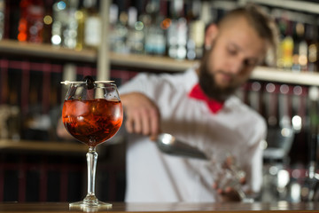 Get ready to drink. Closeup shot of cooling cocktail bartender on the background.