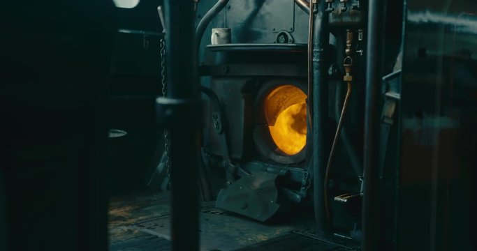 Fire burning in the engine of a steam train