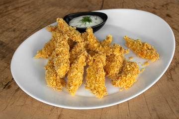 Breaded tenderloin of chicken with cornflakes, topped with dill-mayonnaise sauce with dill.