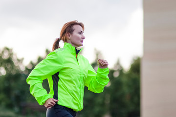 Fitness and Healthy Lifestyle Concepts. Female Athlete Having Running Exercise Outdoors.