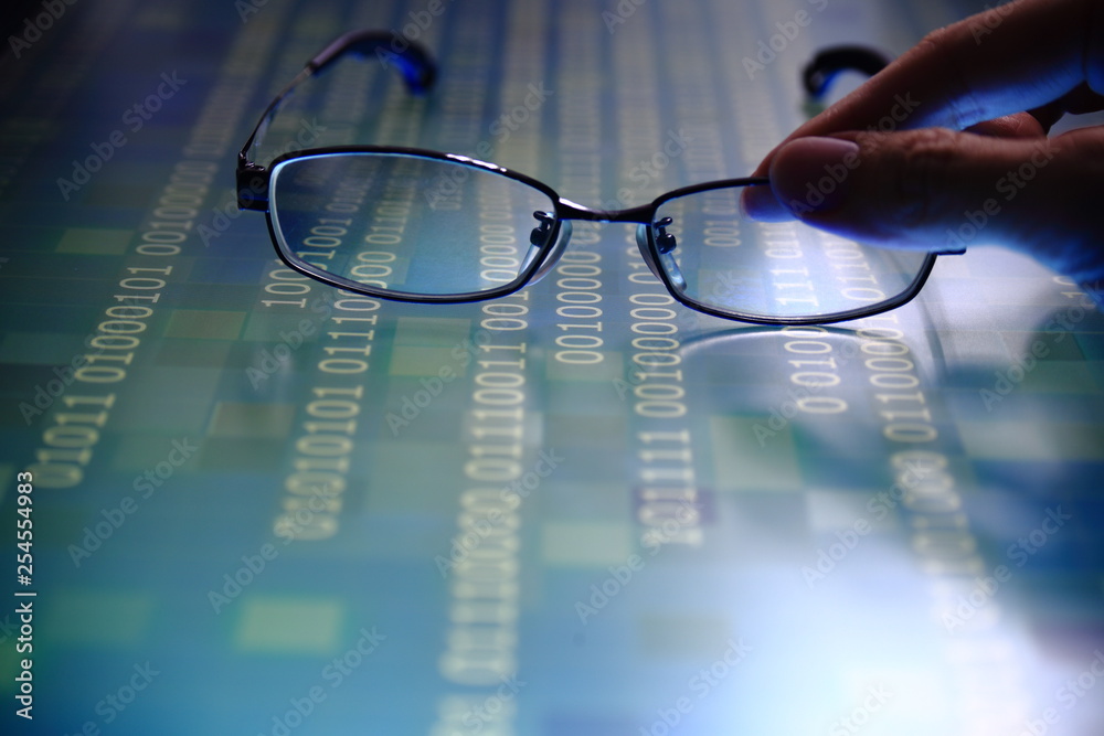 Wall mural hand reaching for glasses on digital led displaying multiple layers of binary code computer data matrix. big data analytics and digital language concepts. random white code on blue grid background