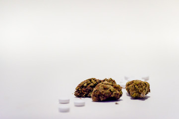 Cannabis marijuana flowers and prescription narcotic pills. Alternative medicine, addiction treatment.
