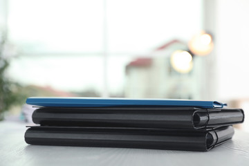 Stack of folders with documents on office table. Space for text