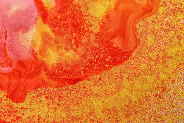 Texture of orange paint with colorful splotches as background, closeup