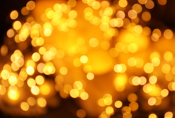 Obraz premium Gold glitter with bokeh effect on dark background