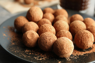 Plate with tasty chocolate truffles, closeup view