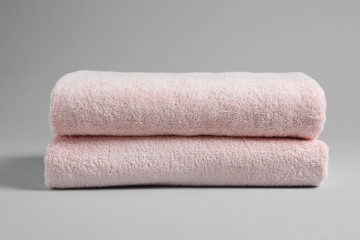 Fresh soft folded towels on light background