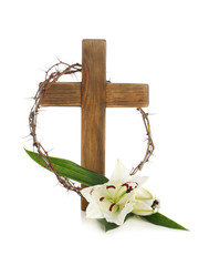 Wooden cross, crown of thorns and blossom lilies on white background