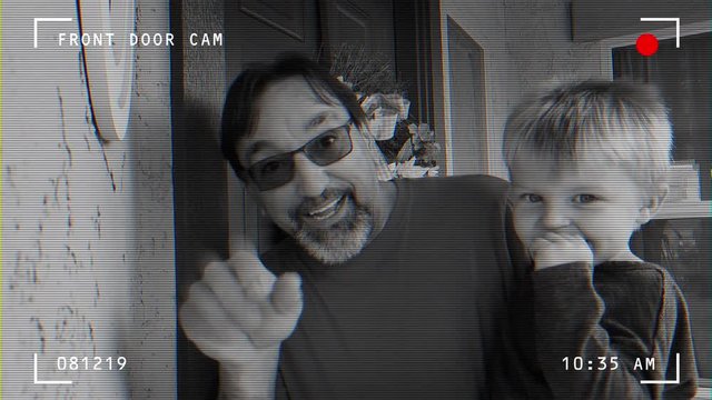 Simulated doorbell camera video feed of a grandfather with grandson waving before entering the house. Phoenix suburbs.  	