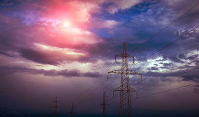  high-voltage  power lines at sunset.