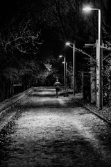 man running alone on an illuminated path