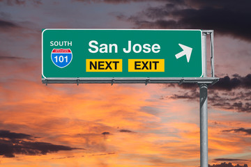 San Jose California next exit route 101 freeway sign with sunset sky.