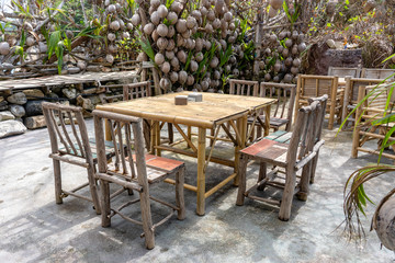 Obraz premium Wooden table and chairs in empty beach cafe next to sea. Island Koh Phangan, Thailand