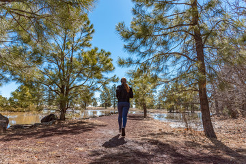 Wide shot of female runner with red hair running away from the camera on a beautiful winter day,