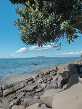 Rngitoto from the right side of mairangi bay beach with the high tide.
