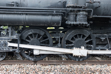 Fototapeta na wymiar Steam Engine Train Wheel on the Tracks Close Up