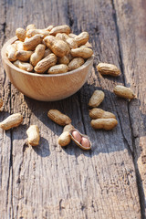 Peanut, snack, in wood bowl on classic wooden table background