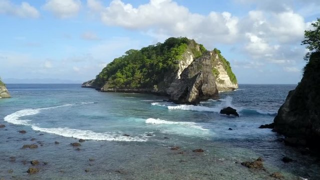 Flying Towards The Horizon With Atuh Beach Natural Rock Island And Beach Wave Water Along The Landscape In Bali Indonesia