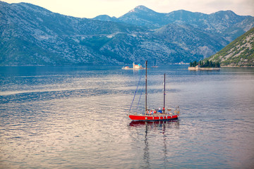 People sailing on modern yacht in Kotor Bay 