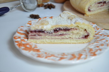 Homemade pie with cherry berries, cup of tea and fork on white wooden table. with ingredients for cooking, cinnamon, anise, icing sugar, topping. homemade baking. copy space. Top view.