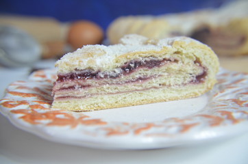 Homemade pie with cherry berries, cup of tea and fork on white wooden table. with ingredients for cooking, cinnamon, anise, icing sugar, topping. homemade baking. copy space. Top view.