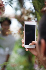 Human hand using smartphone with black screen