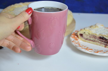 Homemade pie with cherry berries, cup of tea and fork on white wooden table. with ingredients for cooking, cinnamon, anise, icing sugar, topping. homemade baking. copy space. Top view.