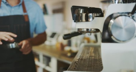 Attractive young barista preparing delicious coffee, barista using espresso machine, coffee shop lifestyle - Powered by Adobe