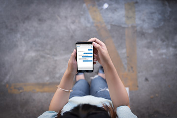Woman using tablet  instant messaging app on mobile