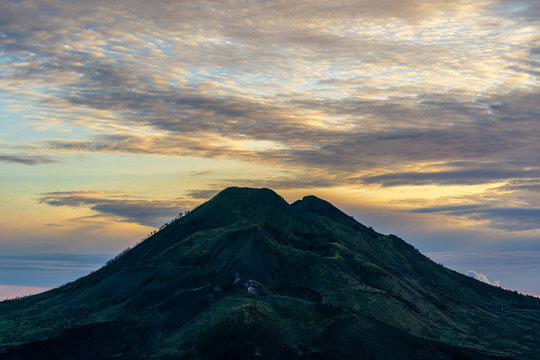 Cloudy landscape with silhoutte of volcano mountains on sunrise. Bali, Indonesia