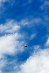 Airplane flying below clouds on decent.