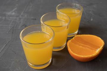 slice orange fruit on concrete table with glass juice