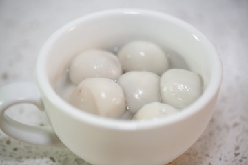 Flat lay Chinese food `tang yuan` glutinous rice ball sweet hot soup on kitchen table top. - Image