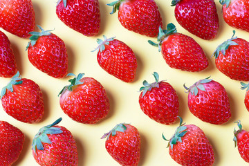 Obraz na płótnie Canvas Pattern of strawberries isolated on yellow background, creative background