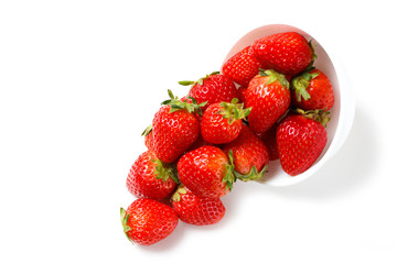Strawberries in a white bowl isolated on white background, side view