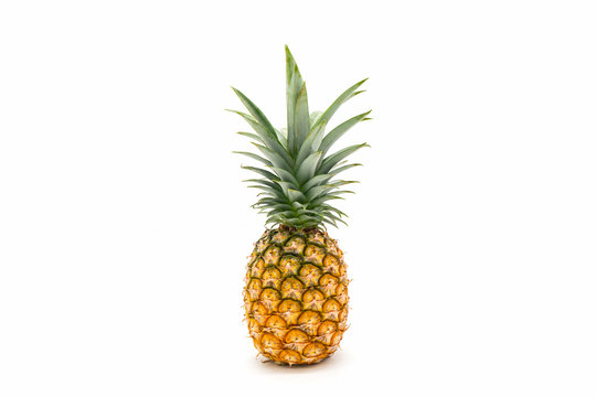 Pineapple with green leaves isolated on white background.