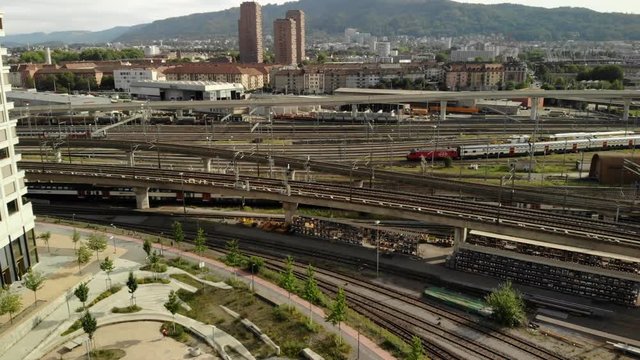 Drone shot rising up and tilting down above SBB train tracks in Z&uuml;rich Switzerland