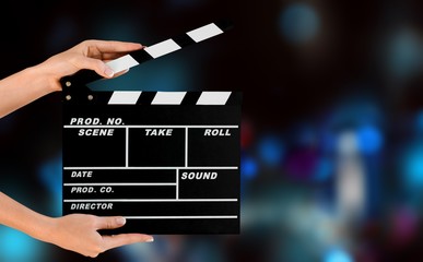 Cinema clapperboard in female hands