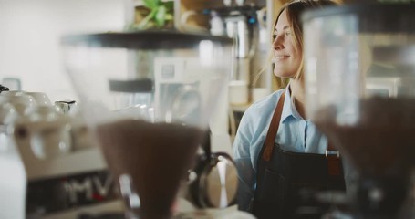 Smiling attractive female barista working in coffee shop, barista using espresso machine, artisan coffee shop lifestyle