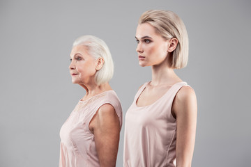 Tidy good-looking women displaying their height and age differences